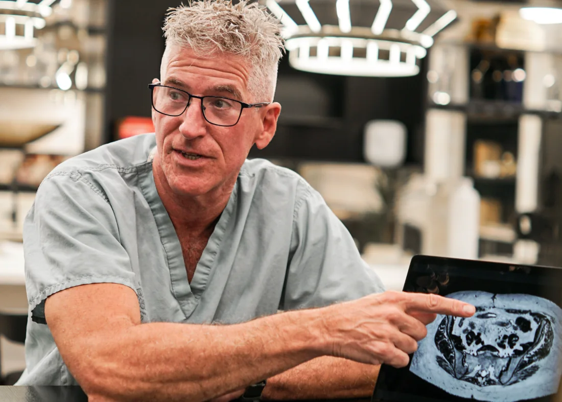Dr. Sean O'Mara pointing at a patient scan